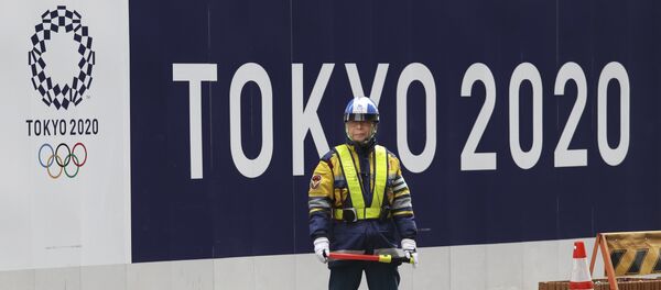 A security guard stands in front of an official logo of the 2020 Tokyo Olympic Games on the safety wall at a construction site in Tokyo's Nihonbashi shopping and office district, Monday, Feb. 6, 2017 A security guard stands in front of an official logo of the 2020 Tokyo Olympic Games on the safety wall at a construction site in Tokyo's Nihonbashi shopping and office district, Monday, Feb. 6, 2017 - Sputnik International