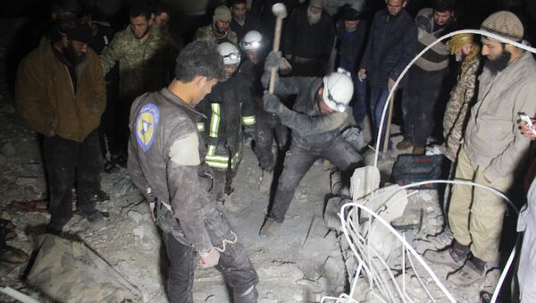 Syrian civil defence volunteers, known as the White Helmets, dig through the rubble of a mosque following a reported airstrike on a mosque in the village of Al-Jineh in Aleppo province late on March 16, 2017 - Sputnik International