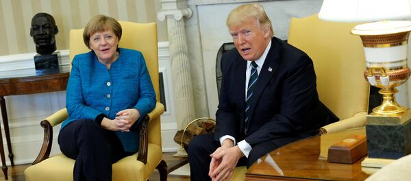 U.S. President Donald Trump and Germany's Chancellor Angela Merkel watch as reporters enter the room before their meeting in the Oval Office at the White House in Washington, U.S. March 17, 2017 - Sputnik International