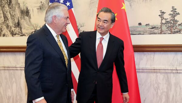 Chinese Foreign Minister Wang Yi (R) talks with U.S. Secretary of State Rex Tillerson at Diaoyutai State Guesthouse on March 18, 2017 in Beijing, China - Sputnik International