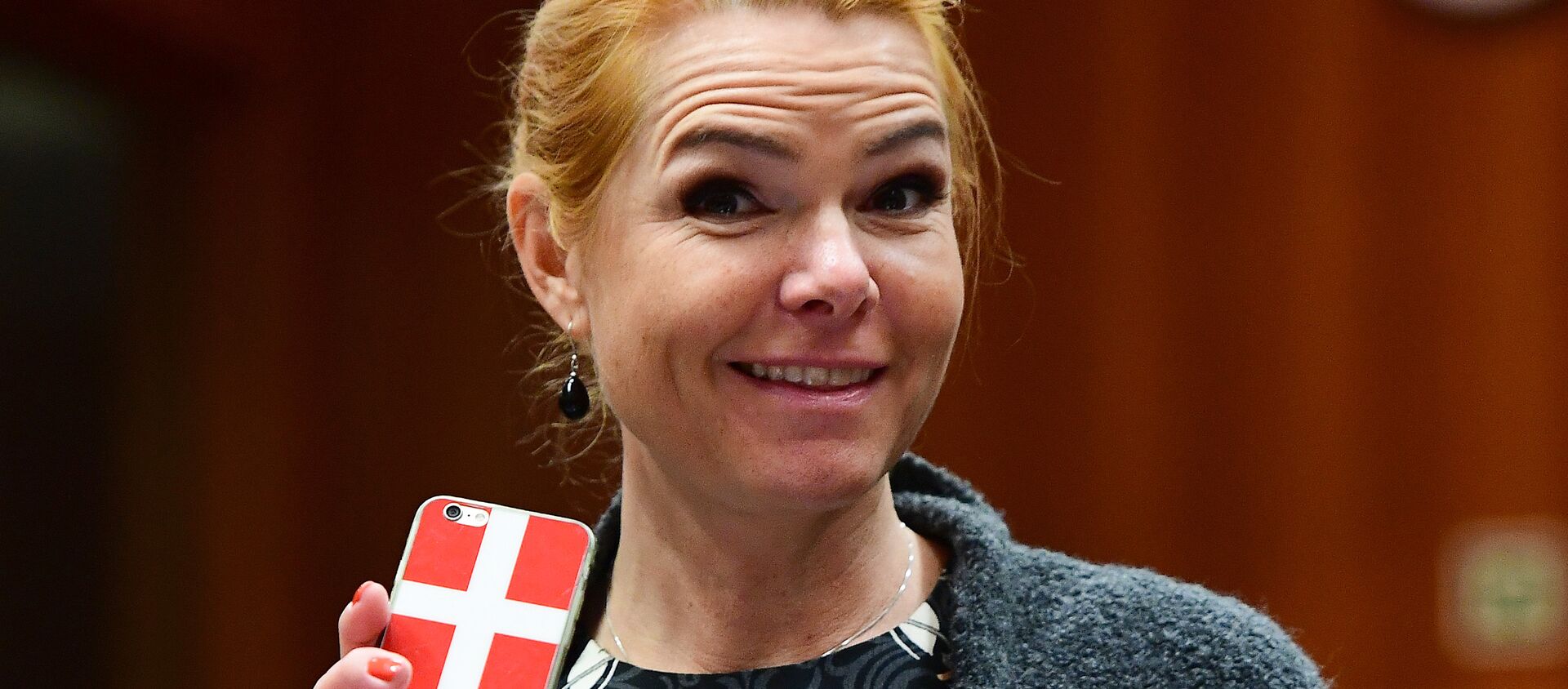Danish Interior Minister Inger Stojberg holds her phone showing a Danish flags as she attends a Justice and Home Affairs Council at the European Council in Brussels on 18 November 2016 - Sputnik International, 1920, 03.09.2021