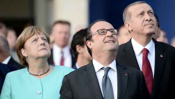 (L-R) German Chancellor Angela Merkel, French President Francois Hollande, and Turkish President Recep Tayyip Erdogan observe the fly-past of NATO countries' jetfighters at the entrance of the National Stadium, the venue of the starting NATO summit, on July 8, 2016 - Sputnik International
