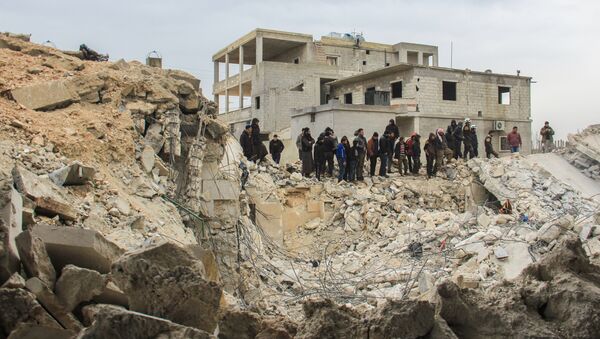 People stand by as Syrian civil defence volunteers, known as the White Helmets, dig through the rubble of a mosque following a reported airstrike on a mosque in the village of Al-Jineh in Aleppo province on March 17, 2017 - Sputnik International
