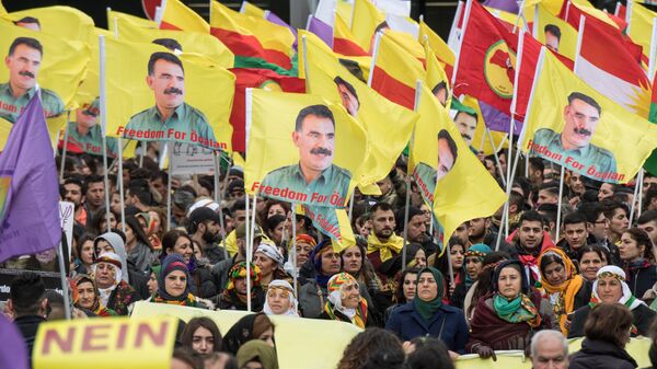Kurdish protesters demonstrate on their way to the Kurdish spring festival Newroz with placards reading No to dictatorship and the portrait of the leader of the Kurdistan PKK Workers' Party, Abdullah Ocalan in the city center of Frankfurt am Main, western Germany, on March 18, 2017 - Sputnik International