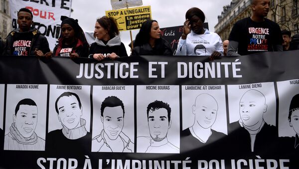 People hold a banner depicting victims of alleged police brutality as they take part in a demonstration called by the families of the victims, LDH, the Mrap, CGT and FSU against police brutality, discrimination and racism in Paris on March 19, 2017 - Sputnik International