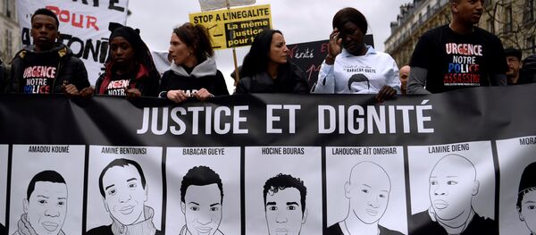 People hold a banner depicting victims of alleged police brutality as they take part in a demonstration called by the families of the victims, LDH, the Mrap, CGT and FSU against police brutality, discrimination and racism in Paris on March 19, 2017 People hold a banner depicting victims of alleged police brutality as they take part in a demonstration called by the families of the victims, LDH, the Mrap, CGT and FSU against police brutality, discrimination and racism in Paris on March 19, 2017 - Sputnik International