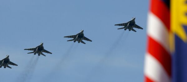 Royal Malaysian Air Force MiG-29 multirole fighters fly in formation over the historic Merdeka Square - Sputnik International
