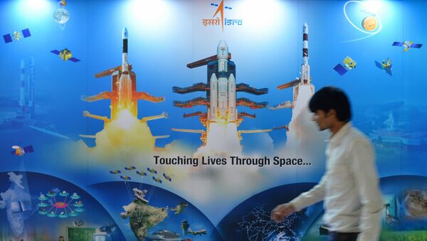 A man walks past a poster of Indian Space Research Organisation (ISRO) - Sputnik International