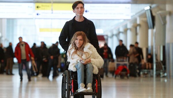 Singer Yulia Samoilova, Russia's Eurovision 2017 contestant, and her husband, Alexei Taran, at Sheremetyevo Airport - Sputnik International