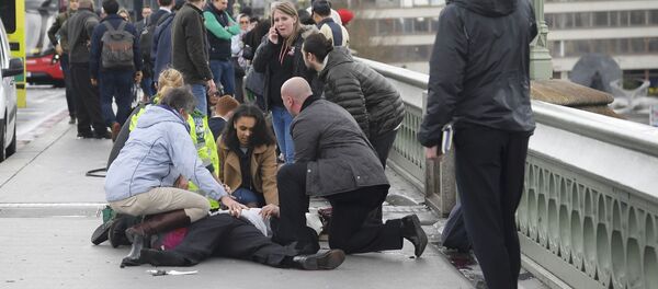 Injured people are assisted after an incident on Westminster Bridge in London Injured people are assisted after an incident on Westminster Bridge in London - Sputnik International
