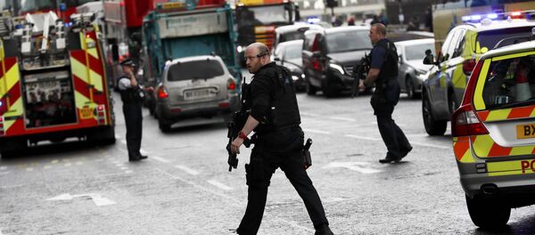 Armed police respond outside Parliament during an incident on Westminster Bridge in London, Britain - Sputnik International