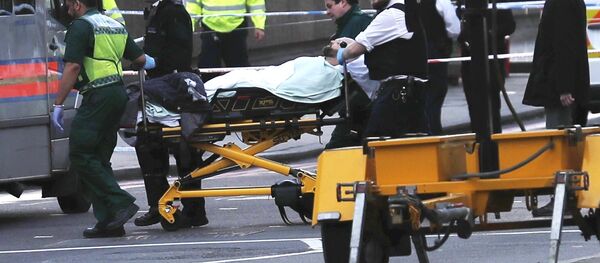Members of the emergency services take an injured person away on a stretcher after an incident on Westminster Bridge in London, Britain Members of the emergency services take an injured person away on a stretcher after an incident on Westminster Bridge in London, Britain - Sputnik International