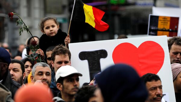 People take part in a march in front of the Brussels Stock Exchange, La Bourse, as part of ceremonies commemorating the first anniversary of twin attacks at Brussels airport and a metro train, Belgium, March 22, 2017. - Sputnik International