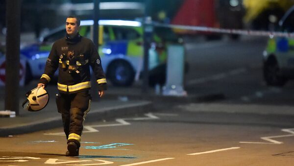 A fire officer works at the scene after an attack on Westminster Bridge in London, Britain, March 22, 2017. - Sputnik International