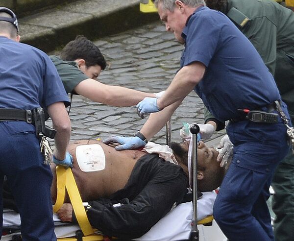 In this March 22, 2017 file photo, the attacker Khalid Masood is treated by emergency services outside the Houses of Parliament London. British Police named on Thursday March 23, 2017, Khalid Masood as The Houses of Parliament attacker. - Sputnik International