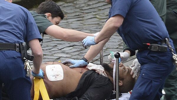 n this March 22, 2017 file photo, the attacker Khalid Masood is treated by emergency services outside the Houses of Parliament London. British Police named on Thursday March 23, 2017, Khalid Masood as The Houses of Parliament attacker. - Sputnik International