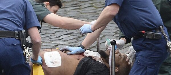 An attacker is treated by emergency services outside the Houses of Parliament London - Sputnik International