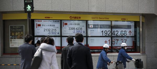 Pedestrians cross a street next to an electric quotation board flashing the Nikkei key index of the Tokyo Stock Exchange (TSE) in Tokyo on March 24, 2017 Pedestrians cross a street next to an electric quotation board flashing the Nikkei key index of the Tokyo Stock Exchange (TSE) in Tokyo on March 24, 2017 - Sputnik International