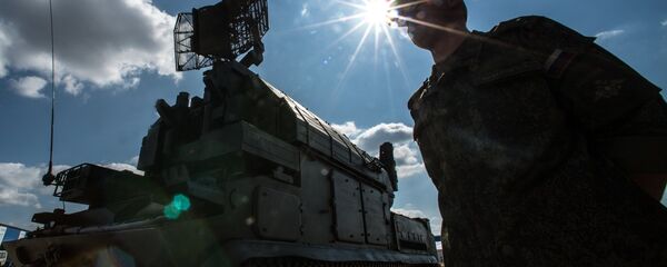 A serviceman is seen near a Tor surface-to-air missile system during preparations for the Engineering Technologies 2014 international forum in Zhukovsky near Moscow - Sputnik International