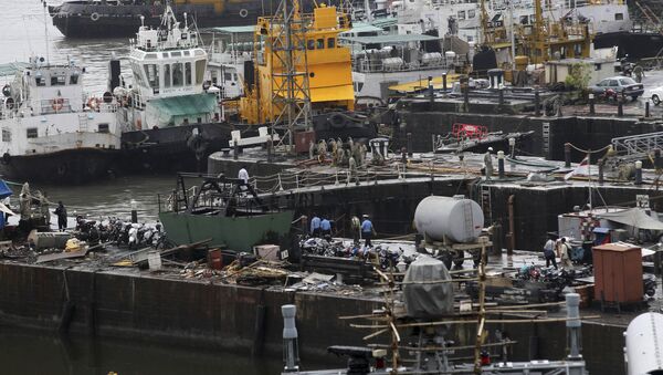 Ships are moored at a naval dockyard where a submarine caught fire and sank after an explosion early Wednesday in Mumbai, India, Wednesday, Aug. 14, 2013 - Sputnik International