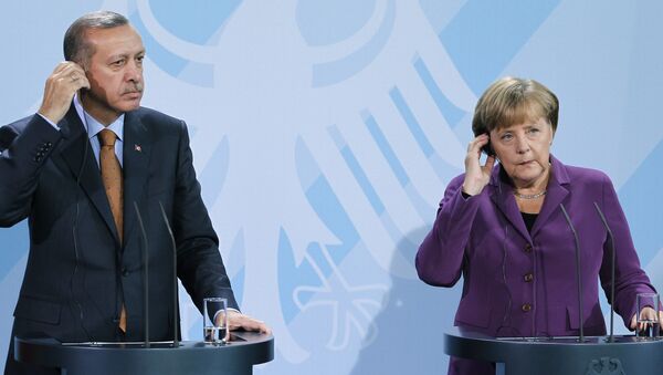 German Chancellor Angela Merkel, right, and Turkey's Prime Minister Recep Tayyip Erdogan, left, address the media during a news conference after a meeting at the Chancellery in Berlin, Germany, Wednesday, Nov. 2, 2011. - Sputnik International