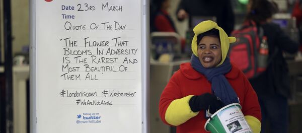 A woman collecting money for charity stands next to a quote written on an information board at Tower Hill underground train station, written in defiance of the previous day's attack in London, Thursday, March 23, 2017. A woman collecting money for charity stands next to a quote written on an information board at Tower Hill underground train station, written in defiance of the previous day's attack in London, Thursday, March 23, 2017. - Sputnik International