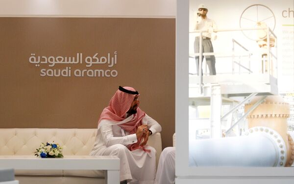 A Saudi Aramco employee sits in the area of its stand at the Middle East Petrotech 2016, an exhibition and conference for the refining and petrochemical industries, in Manama, Bahrain, September 27, 2016. A Saudi Aramco employee sits in the area of its stand at the Middle East Petrotech 2016, an exhibition and conference for the refining and petrochemical industries, in Manama, Bahrain, September 27, 2016. - Sputnik International