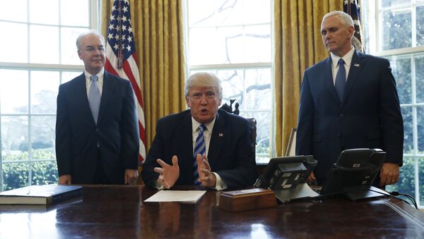 President Donald Trump, flanked by Health and Human Services Secretary Tom Price, left, and Vice President Mike Pence, meets with members of the media regarding the health care overhaul bill, Friday, March 24, 2017, in the Oval Office of the White House in Washington. - Sputnik International