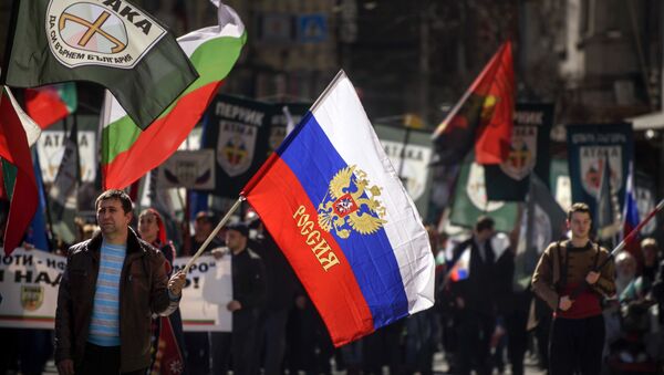 This picture taken on March 3, 2017, shows a man marching with a Russian flag during a political rally on Bulgaria's National Day in central Sofia - Sputnik International