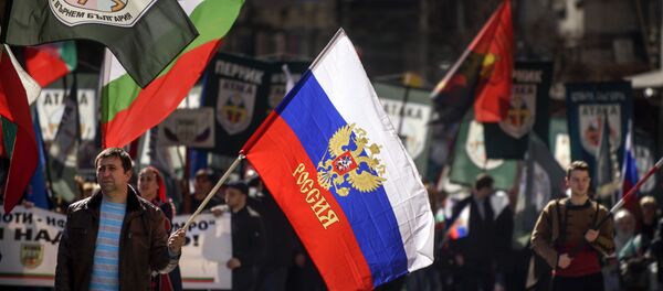 This picture taken on March 3, 2017, shows a man marching with a Russian flag during a political rally on Bulgaria's National Day in central Sofia - Sputnik International