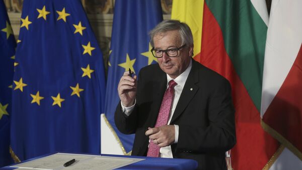 European Commission President Jean-Claude Juncker holds up a pen after signing document during the EU leaders meeting on the 60th anniversary of the Treaty of Rome, in Rome, Italy March 25, 2017 - Sputnik International