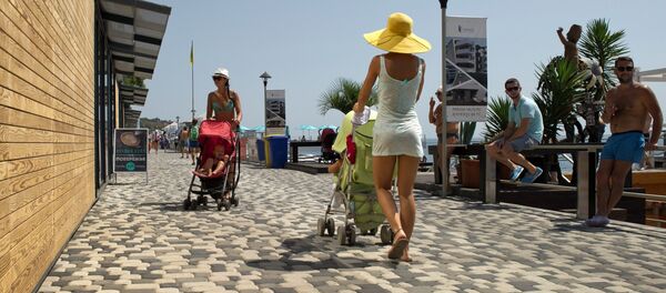 Mothers with baby-strollers walk on the waterfront running along Massandra Beach, Yalta - Sputnik International