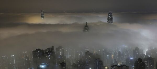High-rise buildings are partly covered by heavy fog at Hong Kong's Victoria Harbour Monday, March 20, 2017. - Sputnik International