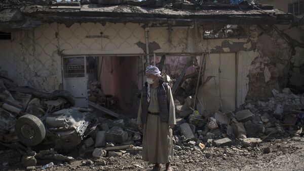 A man stands outside houses damaged during fights between Iraq security forces and Islamic State on the western side of Mosul, Iraq, Friday, March 24, 2017. - Sputnik International