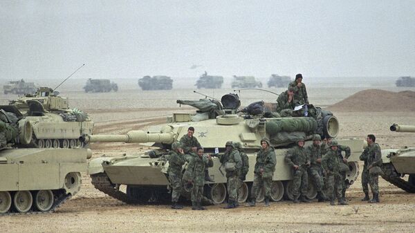 Troops from the Army’s 1st Infantry Division lean on an M1A1 Abrams main battle tank as a convoy passes in the background at an assembly point in afternoon on Sunday, Jan. 21, 1991 in Saudi Arabia. Troops from the 1st Infantry Division have taken up positions close to the border with Kuwait - Sputnik International