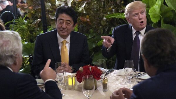 President Donald Trump, second from right, sits down to dinner with Japanese Prime Minister Shinzo Abe, second from left, at Mar-a-Lago in Palm Beach, Fla., Friday, Feb. 10, 2017. Robert Kraft, owner of the New England Patriots, is at left. Trump is hosting Abe and his wife for the weekend. - Sputnik International