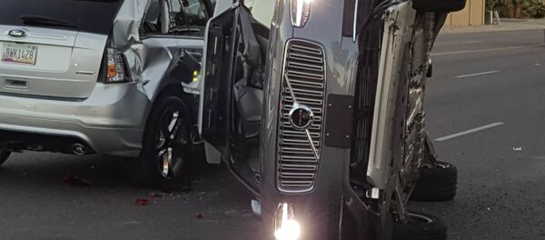 A self-driven Volvo SUV owned and operated by Uber Technologies Inc. is flipped on its side after a collision in Tempe, Arizona, U.S. on March 24, 2017. A self-driven Volvo SUV owned and operated by Uber Technologies Inc. is flipped on its side after a collision in Tempe, Arizona, U.S. on March 24, 2017. - Sputnik International