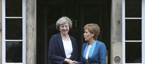 Scotland's First Minister Nicola Sturgeon greets Britain's new Prime Minister Theresa May as she arrives at Bute House in Edinburgh, July 15, 2016. Scotland's First Minister Nicola Sturgeon greets Britain's new Prime Minister Theresa May as she arrives at Bute House in Edinburgh, July 15, 2016. - Sputnik International