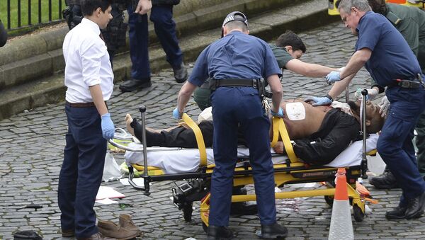 FILE- In this March 22, 2017 file photo, the attacker Khalid Masood is treated by emergency services outside the Houses of Parliament London. British Police named on Thursday March 23, 2017, Khalid Masood as The Houses of Parliament attacker - Sputnik International