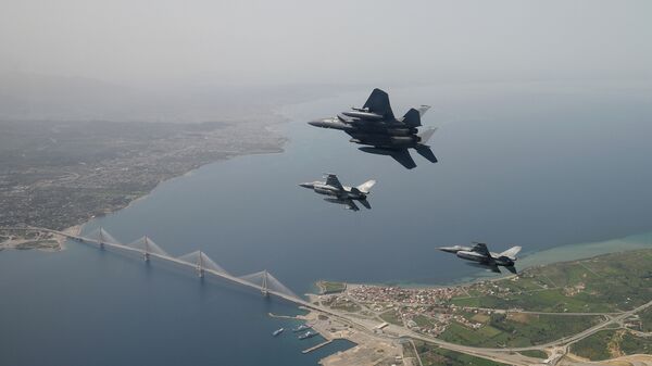 In this photo released by the Hellenic Air Force, two Greek F-16 fighter jets and a USAF F-15E Strike Eagles, based at Lakenheath airbase in England, fly past the 2,880-meter Rio-Antirrio Bridge in southern Greece, on Wednesday, April 13, 2016. The U.S. jets took part in Exercise Iniohos 2016, in southern Greece, together with military aircraft from Greece and Israel. - Sputnik International