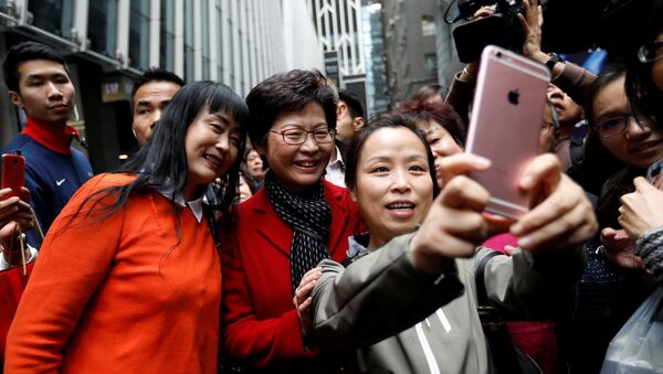 People take selfies with Carrie Lam, chief executive-elect, a day after she was elected in Hong Kong, China March 27, 2017 - Sputnik International