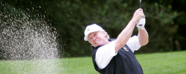 Donald Trump hits out of the sand on the first hole of the Poppy Hills Golf Course - Sputnik International