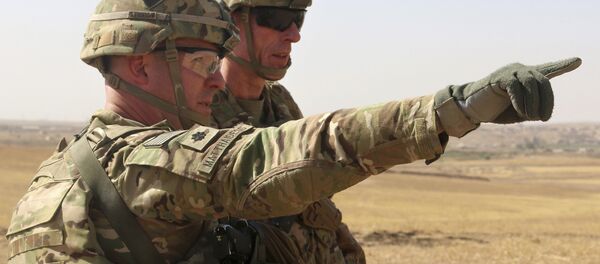 This Oct. 10, 2016 photo released by the U.S. Army shows U.S. Army Lt. Col. Ed Matthaidess, commander, left, Task Force Falcon, outlining areas of an Iraqi security forces tactical assembly area to U.S. Army Maj. - Sputnik International