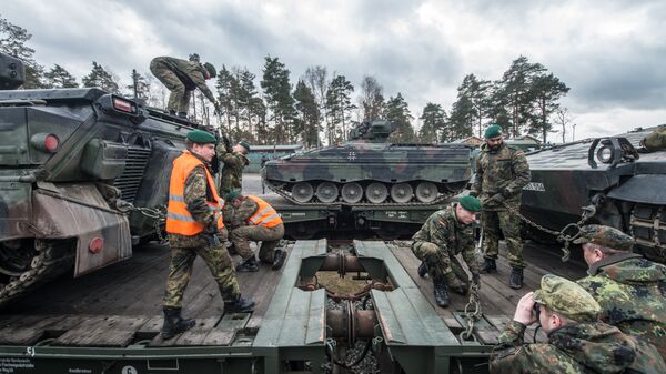 German soldiers load armored vehicles of the type Marder on a train at the troop exercise area in Grafenwoehr, southern Germany, on February 21, 2017. - Sputnik International