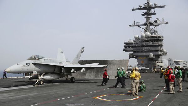 In this Wednesday, March 22, 2017 photograph, sailors prepare to launch an F-18 off of the USS George H.W. Bush as it travels through the Persian Gulf. - Sputnik International