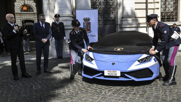 Italy's Interior Minister Marco Minniti (L) unveils the new police's car Lamborghini Huracan next to Stefano Domenicali, Chief Executive Officer of Automobil Lamborghini, during a press conference at the Interior Ministry Viminale in Rome, on March 30, 2017. - Sputnik International