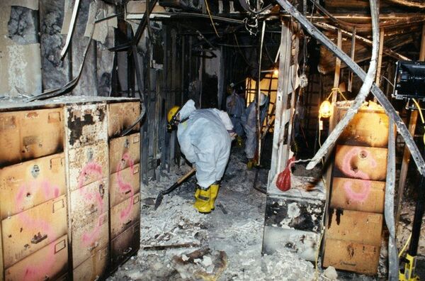 Workers scrape through the debris left behind in the ravaged west wing of the Pentagon. - Sputnik International