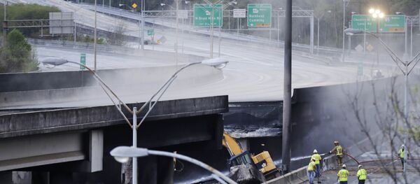 Crews work on a section of an overpass that collapsed from a large fire on Interstate 85 in Atlanta, Friday, March 31, 2017. Many commuters in some of Atlanta's densely populated northern suburbs will have to find alternate routes or ride public transit for the foreseeable future after a massive fire caused a bridge on Interstate 85 to collapse Thursday, completely shutting down the heavily traveled highway. - Sputnik International