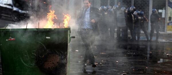 A journalist runs during a demonstration against a possible change in law to allow for presidential re-election in front of the Congress building in Asuncion, Paraguay, March 31, A journalist runs during a demonstration against a possible change in law to allow for presidential re-election in front of the Congress building in Asuncion, Paraguay, March 31, - Sputnik International