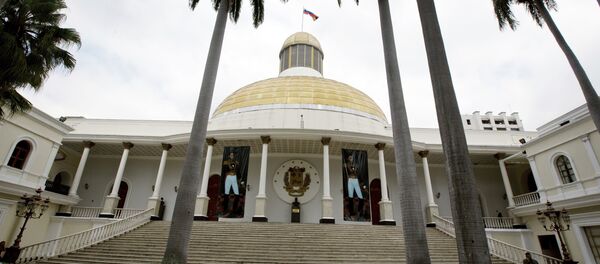 A Bolivarian National Guard officer speaks by cellphone near the stairs of the National Assembly in Caracas, Venezuela, Thursday, Jan. 12, 2017 - Sputnik International